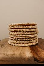 Stack of crackers on a wooden surface with a neutral background