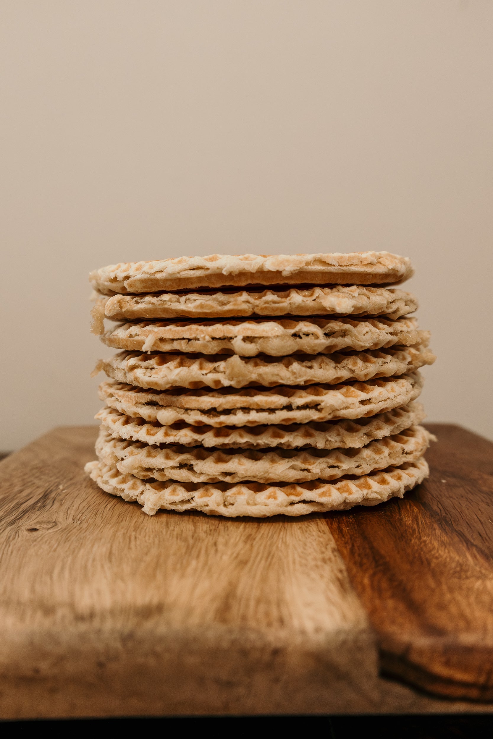 Stack of crackers on a wooden surface with a neutral background