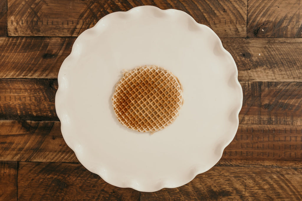 Waffle on a white plate against a wooden background